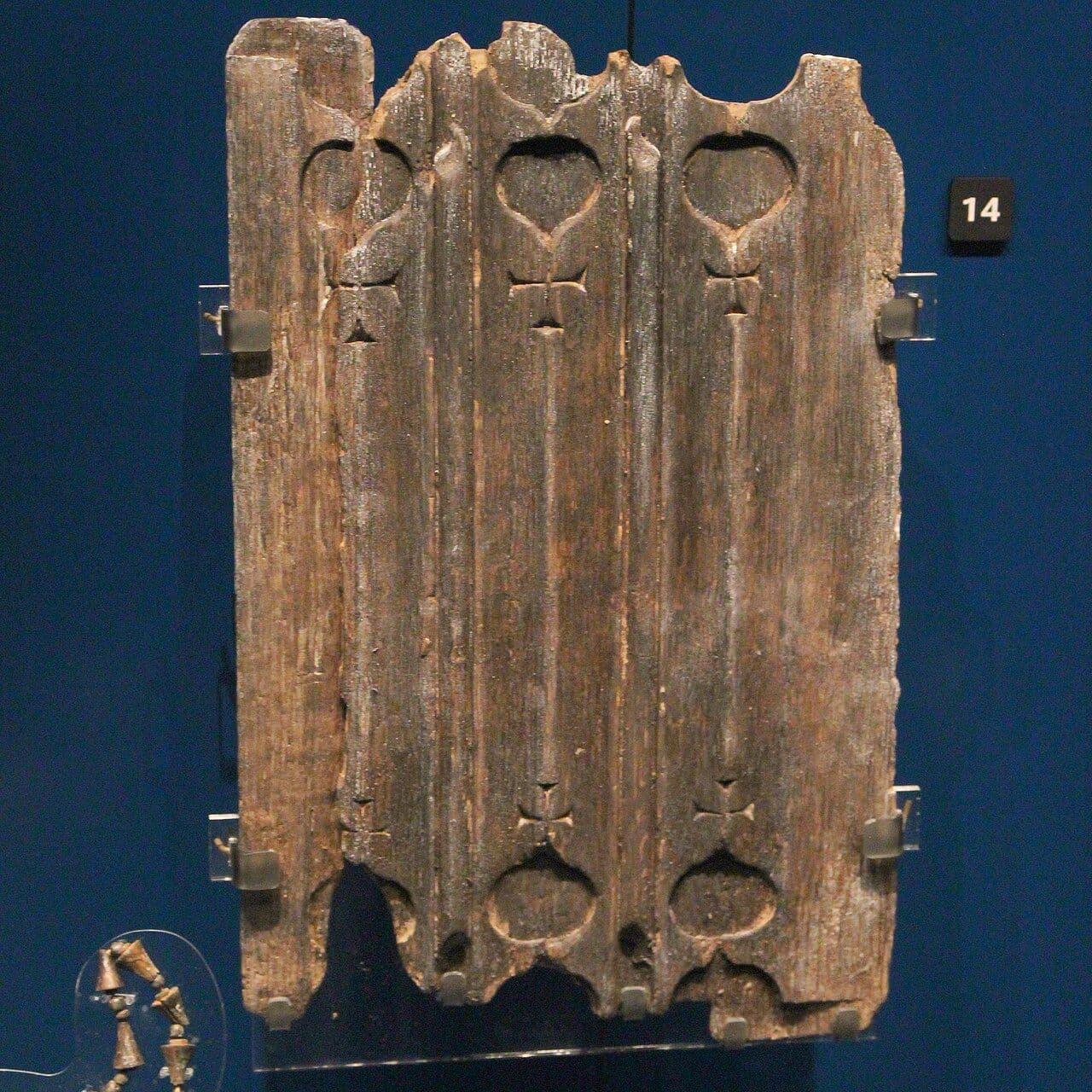 Close-up of a carved oak linenfold panel with a small cross motif