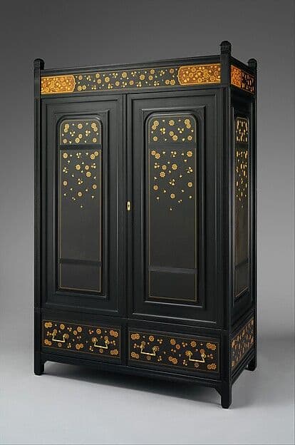 Tall dark two-door wardrobe with small scattered floral inlays on recessed door panels