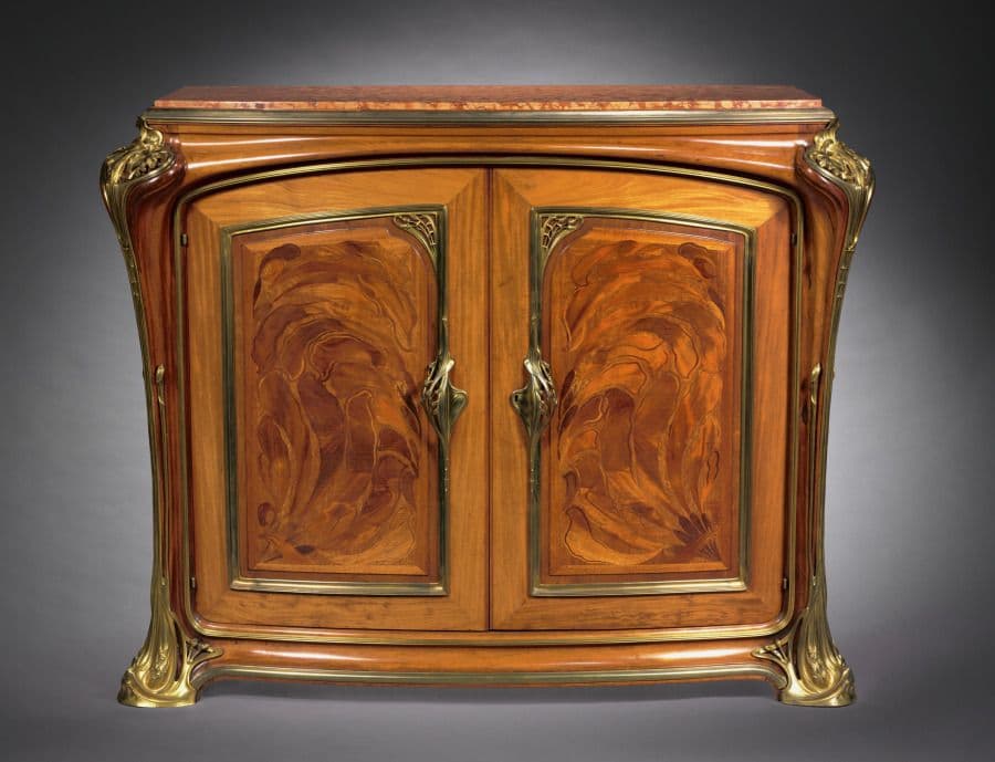 Art Nouveau cabinet with flowing abstract wood marquetry on curved doors and metal mounts