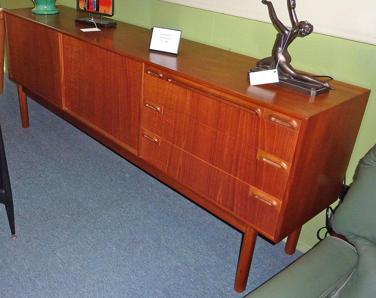 Teak mid-century sideboard with drawers and cupboard doors on tapered legs