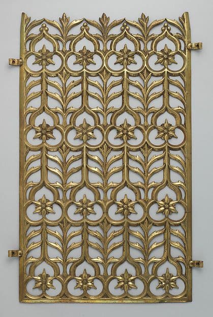 Brass grille with a repeating Gothic lattice of stylized leaves and flowers