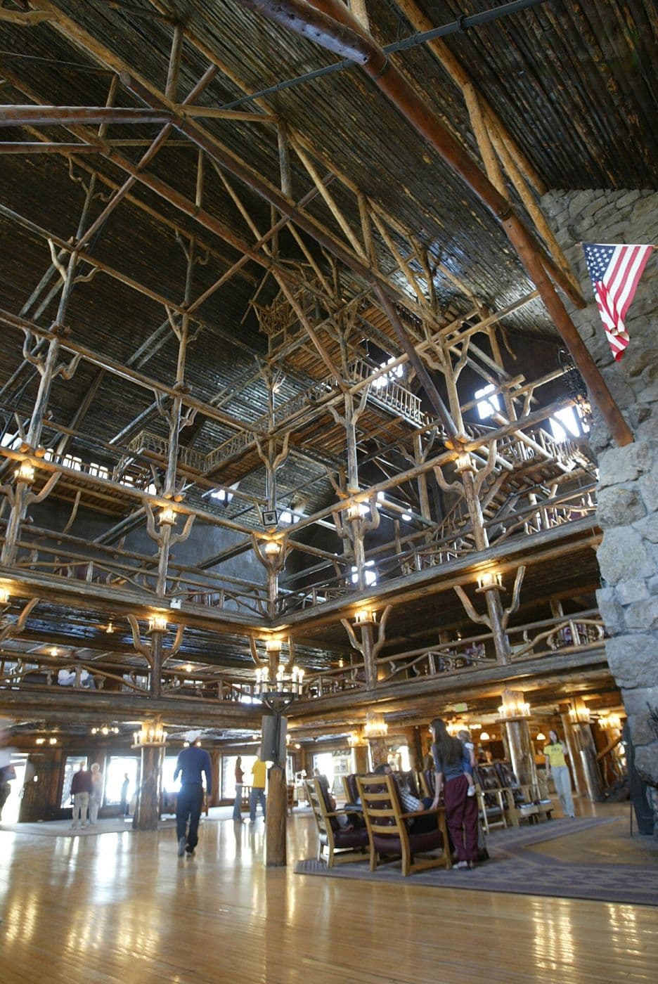 Log lobby structure with gnarled branching brackets and railings rising to the roof