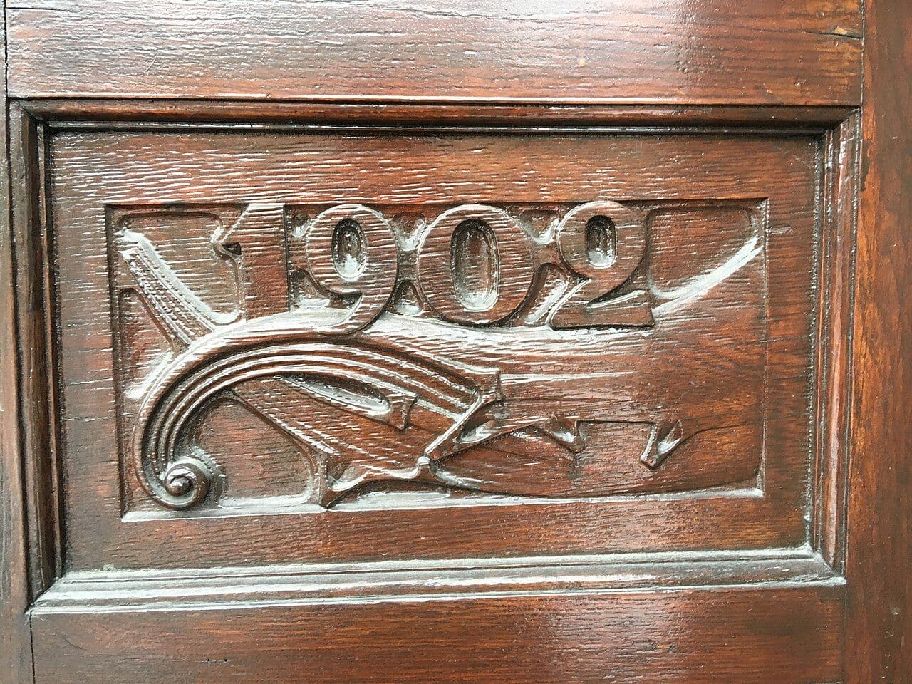 Carved wooden main door with flowing Art Nouveau decoration at a museum in Oslo