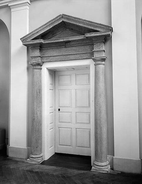 Georgian doorway with a stone surround and a paneled wooden door