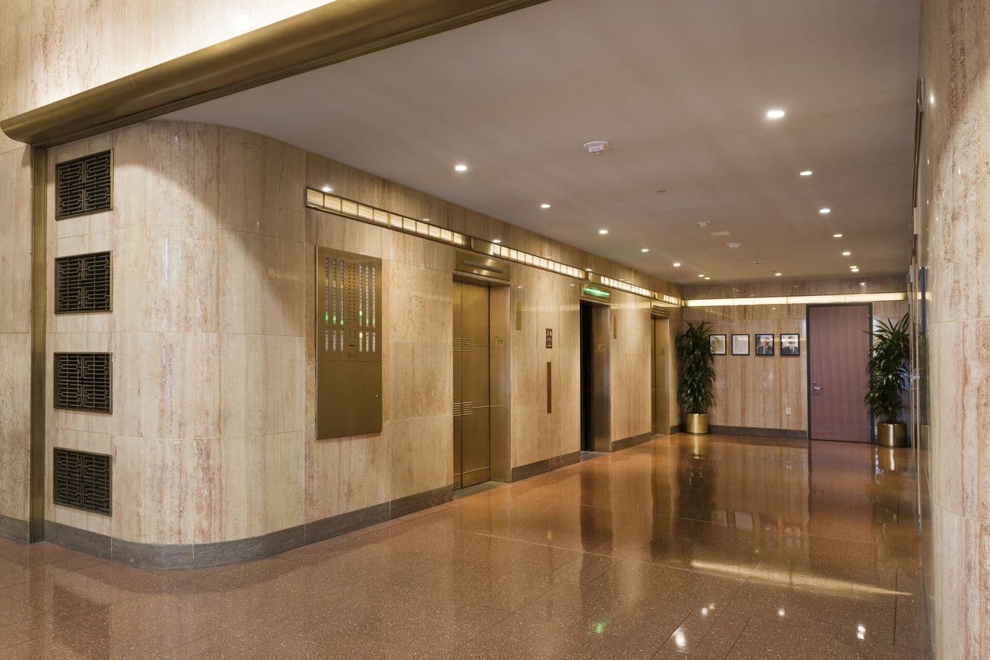 Moderne elevator lobby with polished walls and metal elevator doors