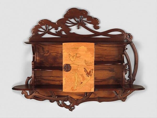 Small Art Nouveau hanging cabinet with a carved cow parsley crest and inlaid door