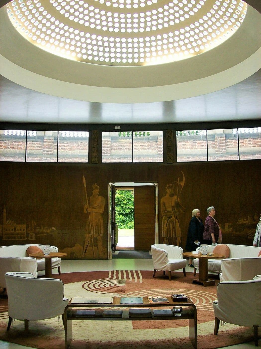 Circular Art Deco entrance hall with wood veneer walls, marquetry panels and a glass dome