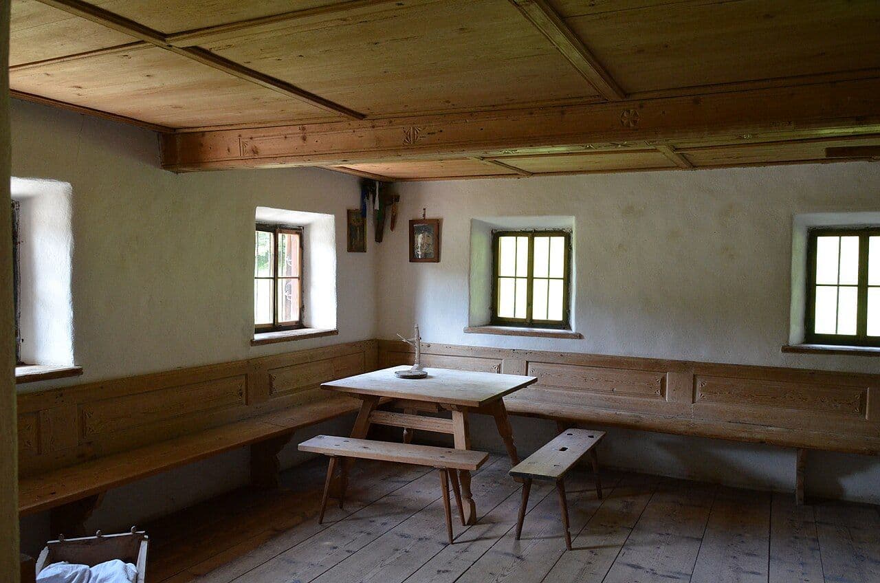 Tyrolean farmhouse room with aged wood paneling and built-in benches