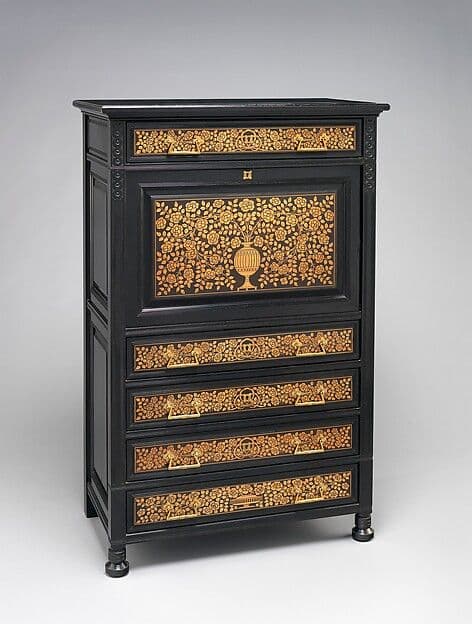 Black ebonized secretary with bands of golden floral marquetry on the drawer fronts and fall front