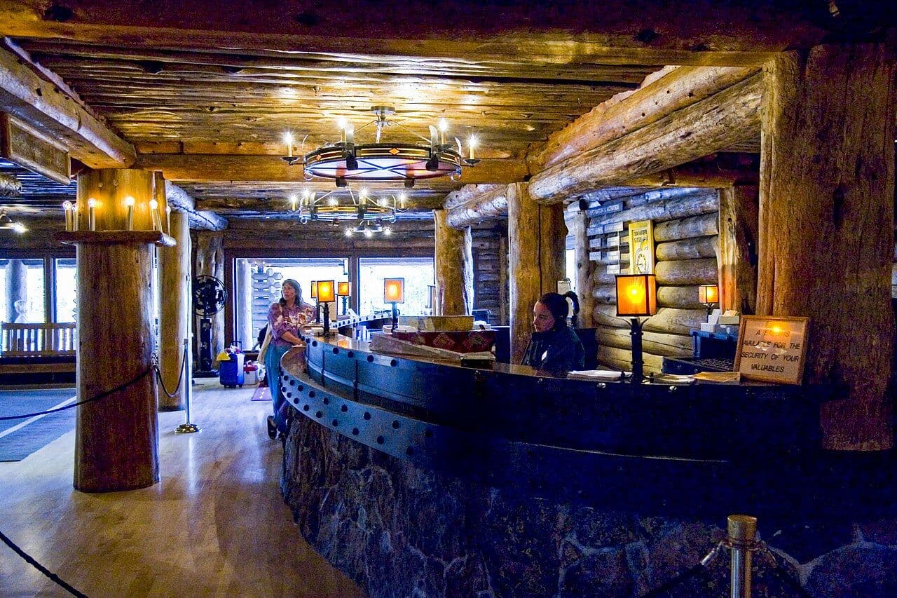 Curved log-framed reception desk in the Old Faithful Inn lobby