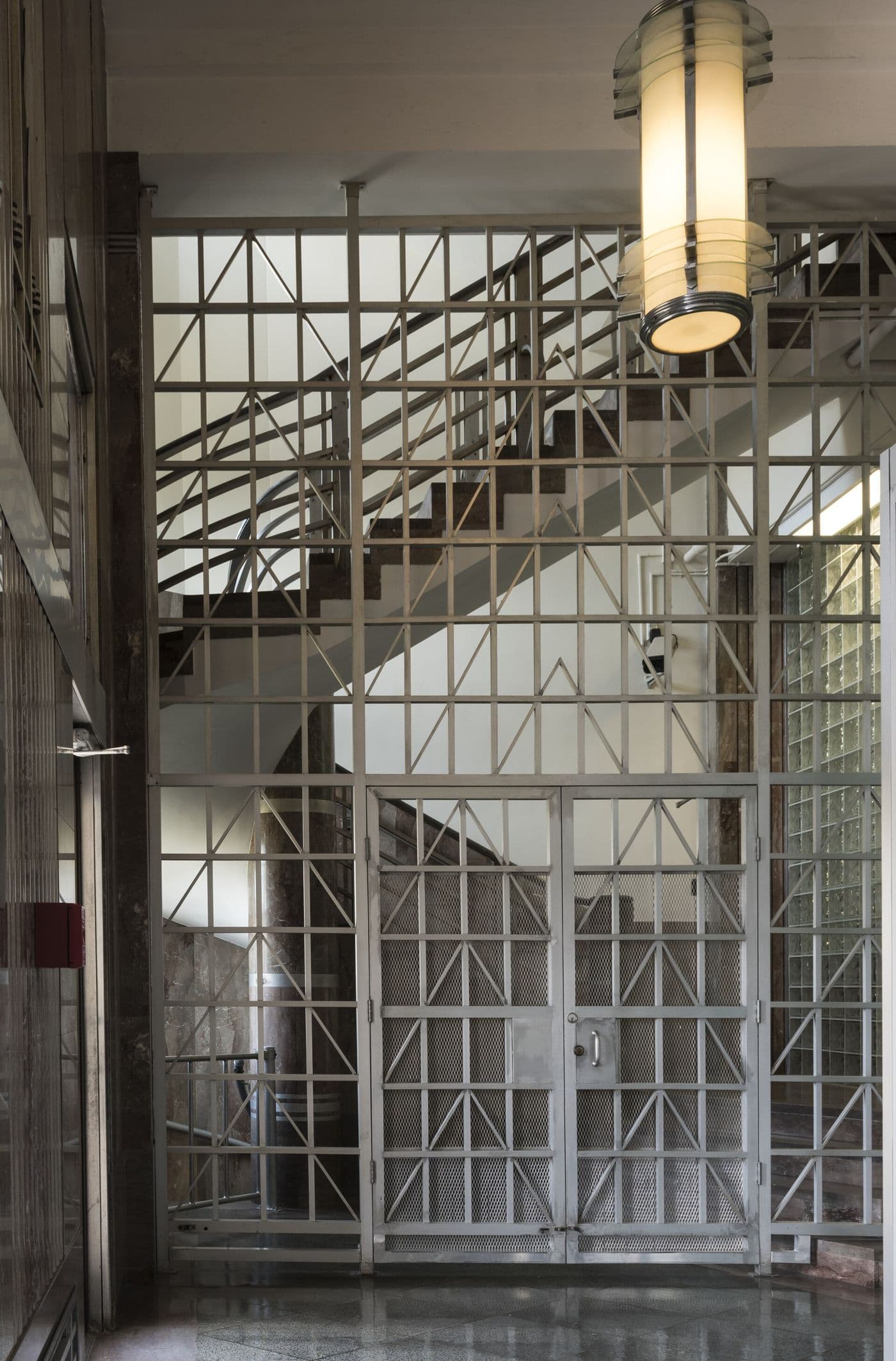 Decorative Art Deco metal screen beside a lobby stairway
