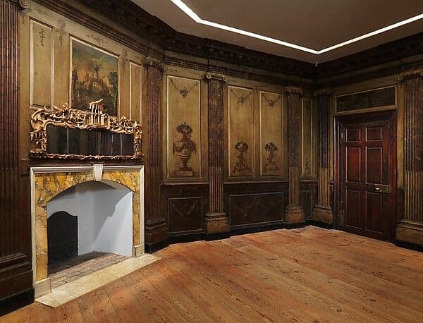 Colonial parlor paneling with pilasters, built-in cupboards and decoratively painted panels