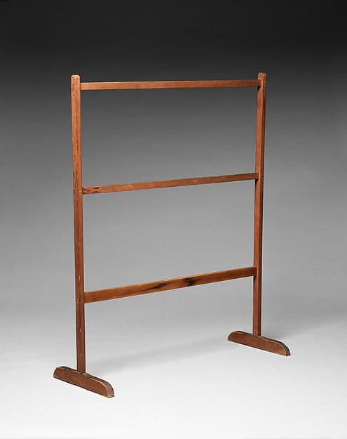 Simple wooden Shaker drying rack with three rails and arched feet