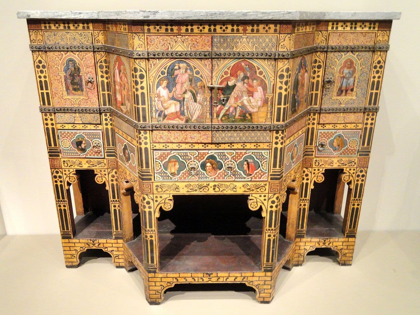 Painted Gothic Revival cabinet with arcaded front and colorful figurative panels